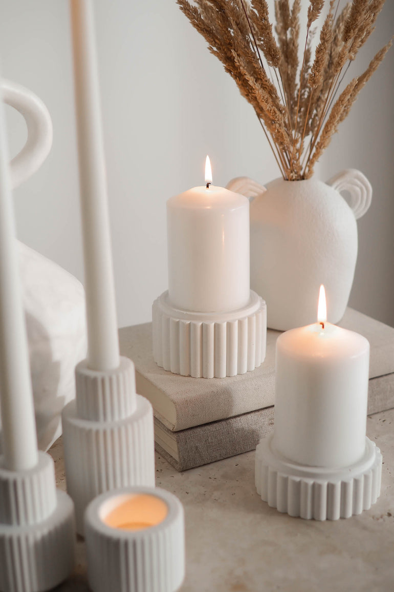 Preston candle holders and Palmer candle holders displayed with lit candles