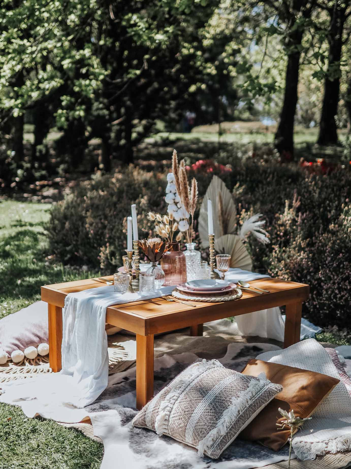 Pink picnic proposal in a manicured garden