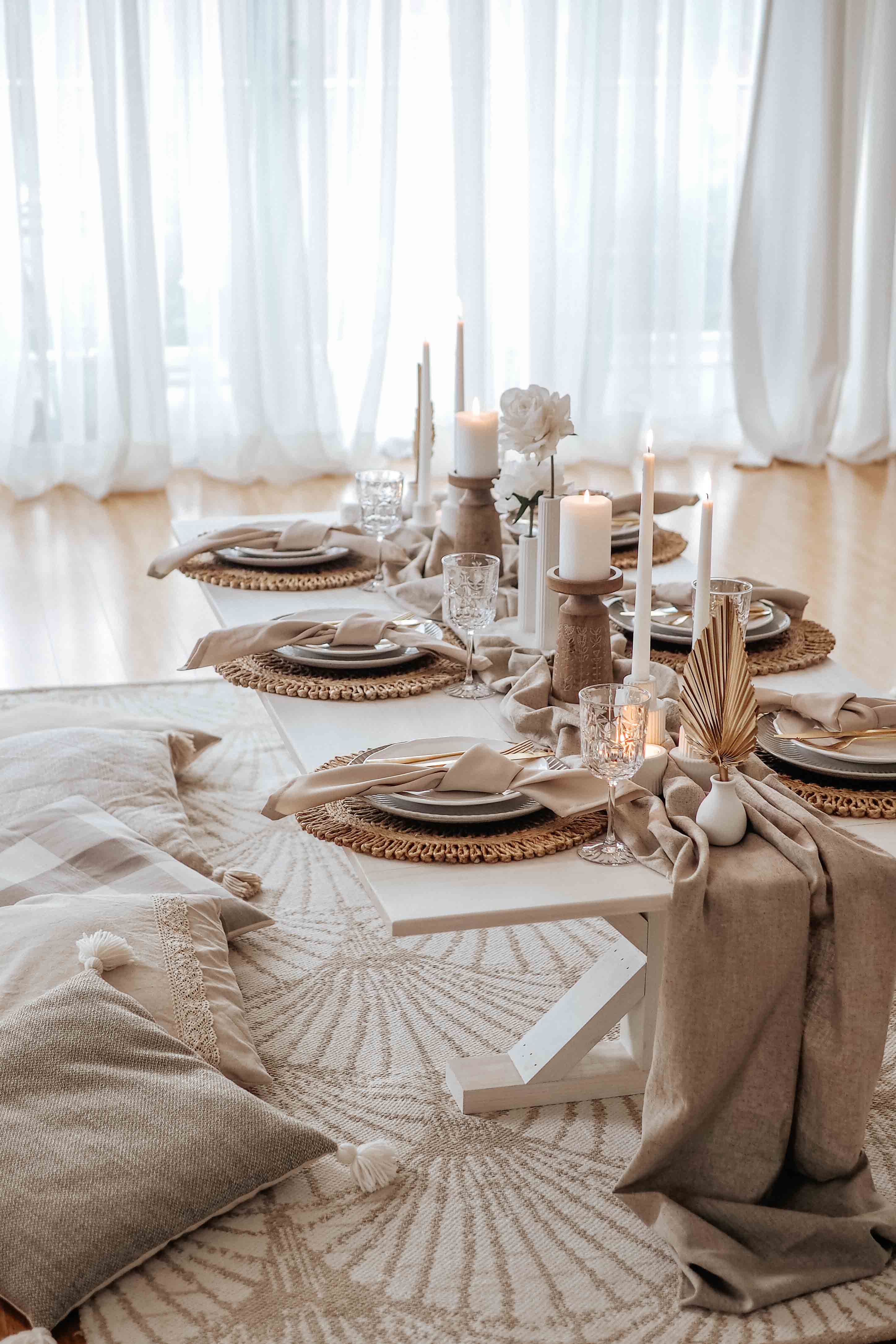 Indoor taupe picnic set up with taper candle holders and natural decor