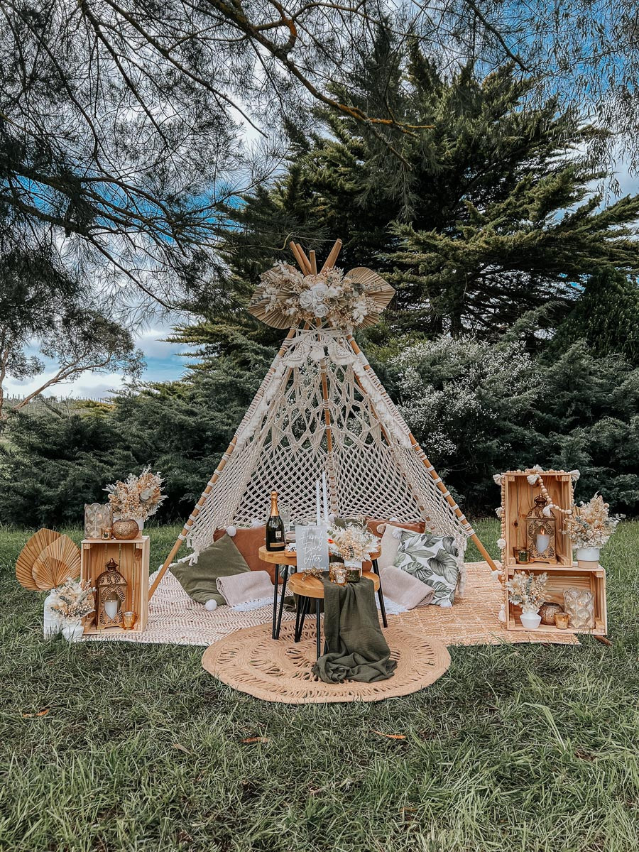 Surprise picnic proposal at K1 Winery - macrame teepee with cushions and sage green accents