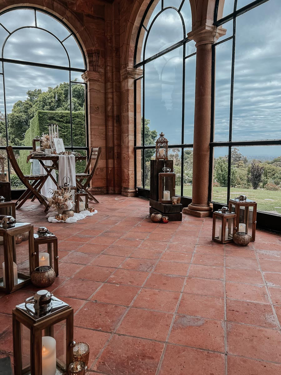 Surprise proposal set up with open vintage windows and lantern pathway