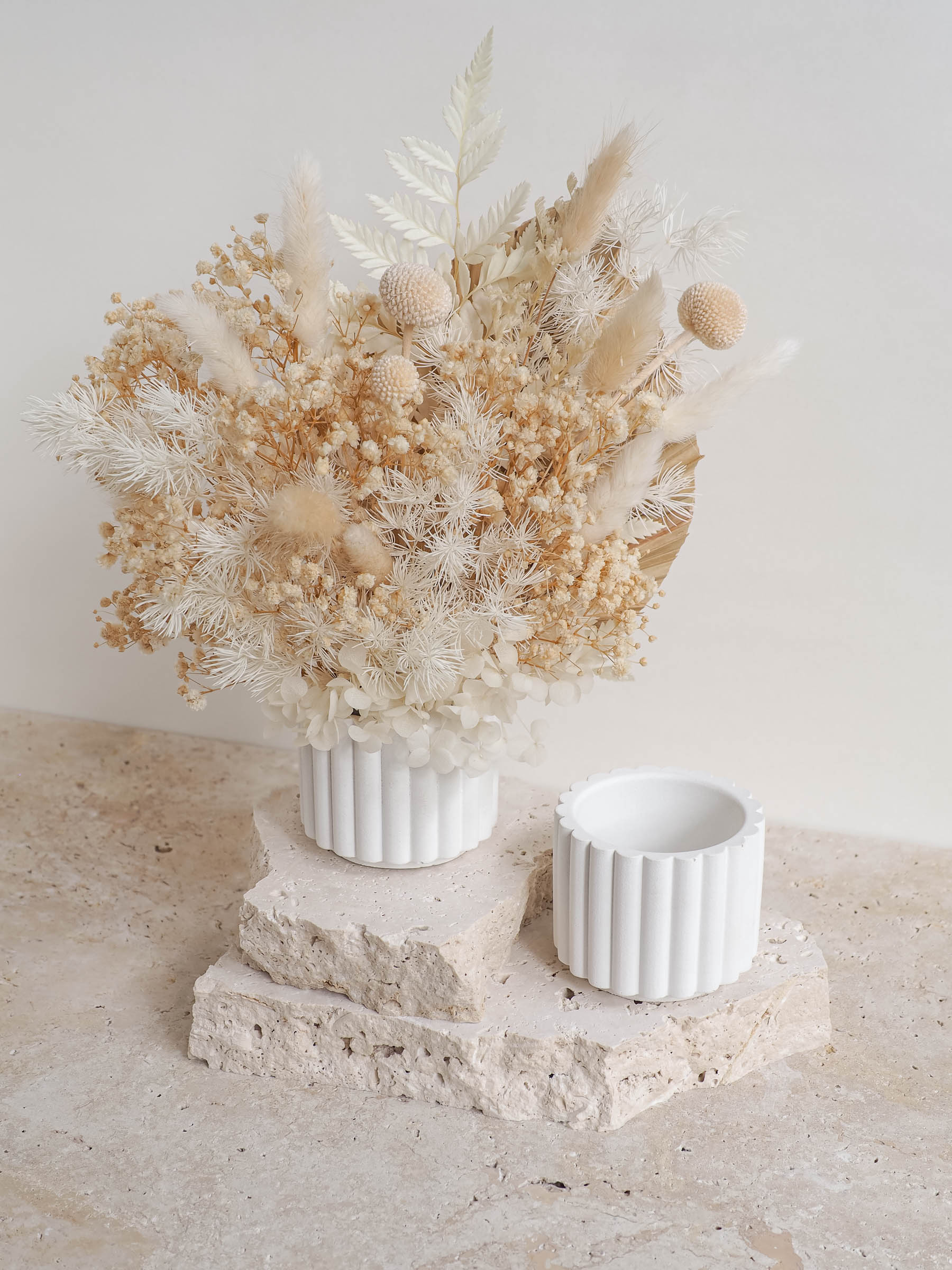 Florence mini scalloped vase with dried floral arrangements on a travertine table
