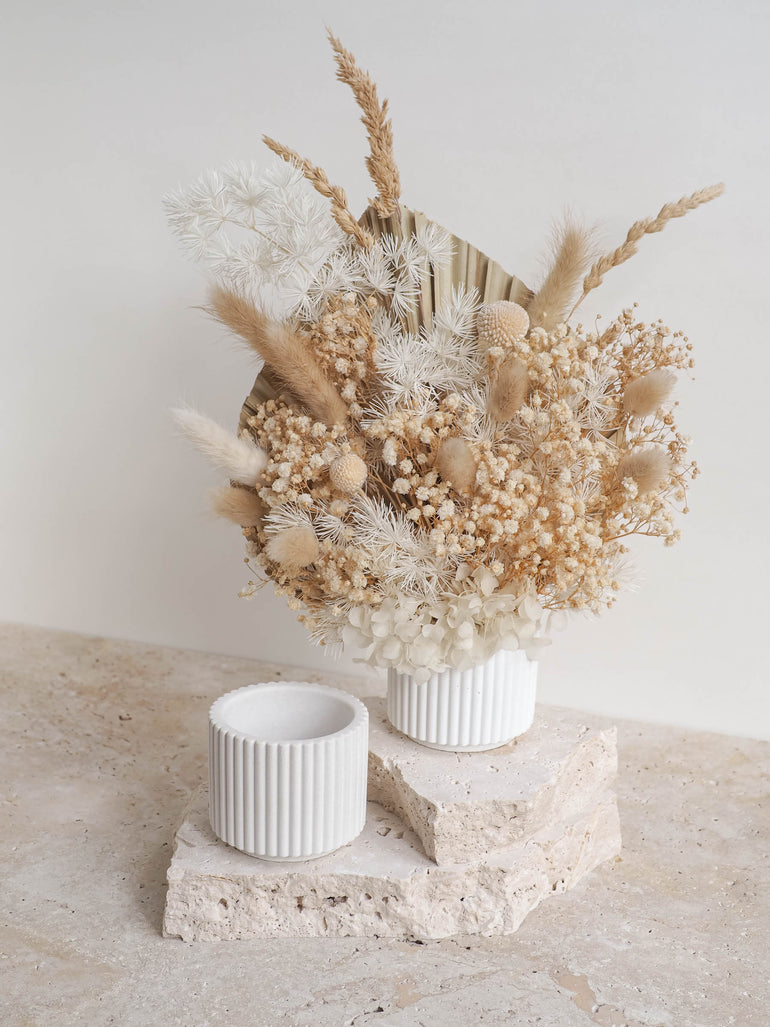 Hunter mini ribbed concrete pot displayed with a neutral dried floral arrangement