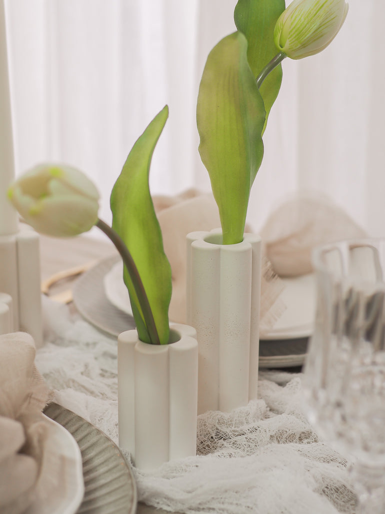 Close up of Palomino vases with white tulips in them
