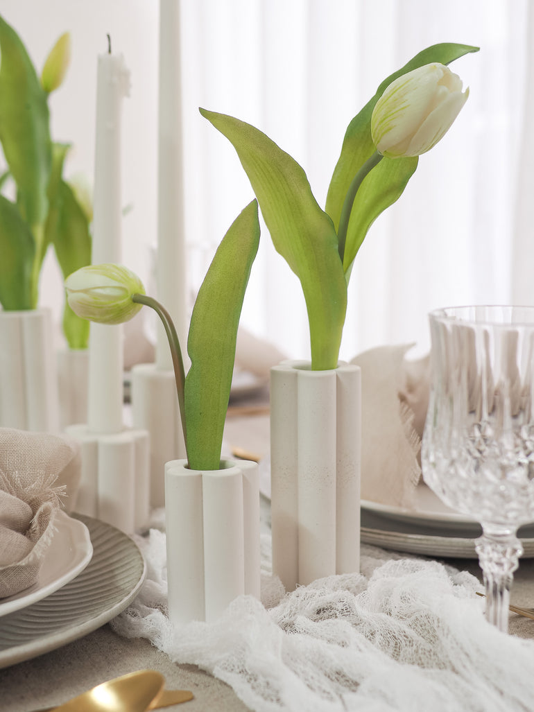 Close up view of Palomino vases on a taupe table setting
