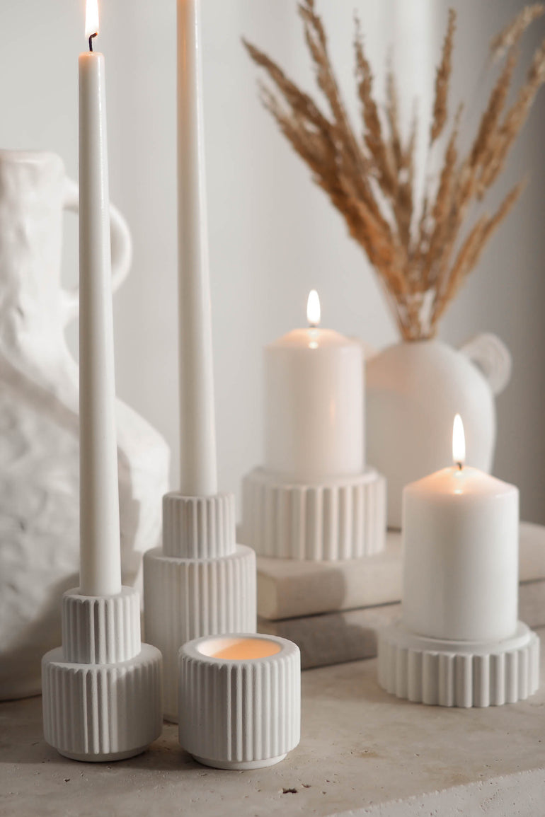 Close up photo of our off white Palmer concrete candle holders and our Preston scalloped candle holders