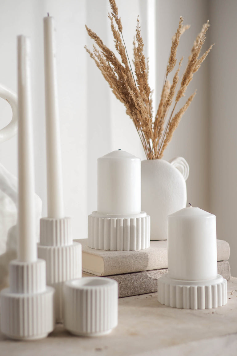 Preston candle holders and Palmer candle holders displayed on a travertine table