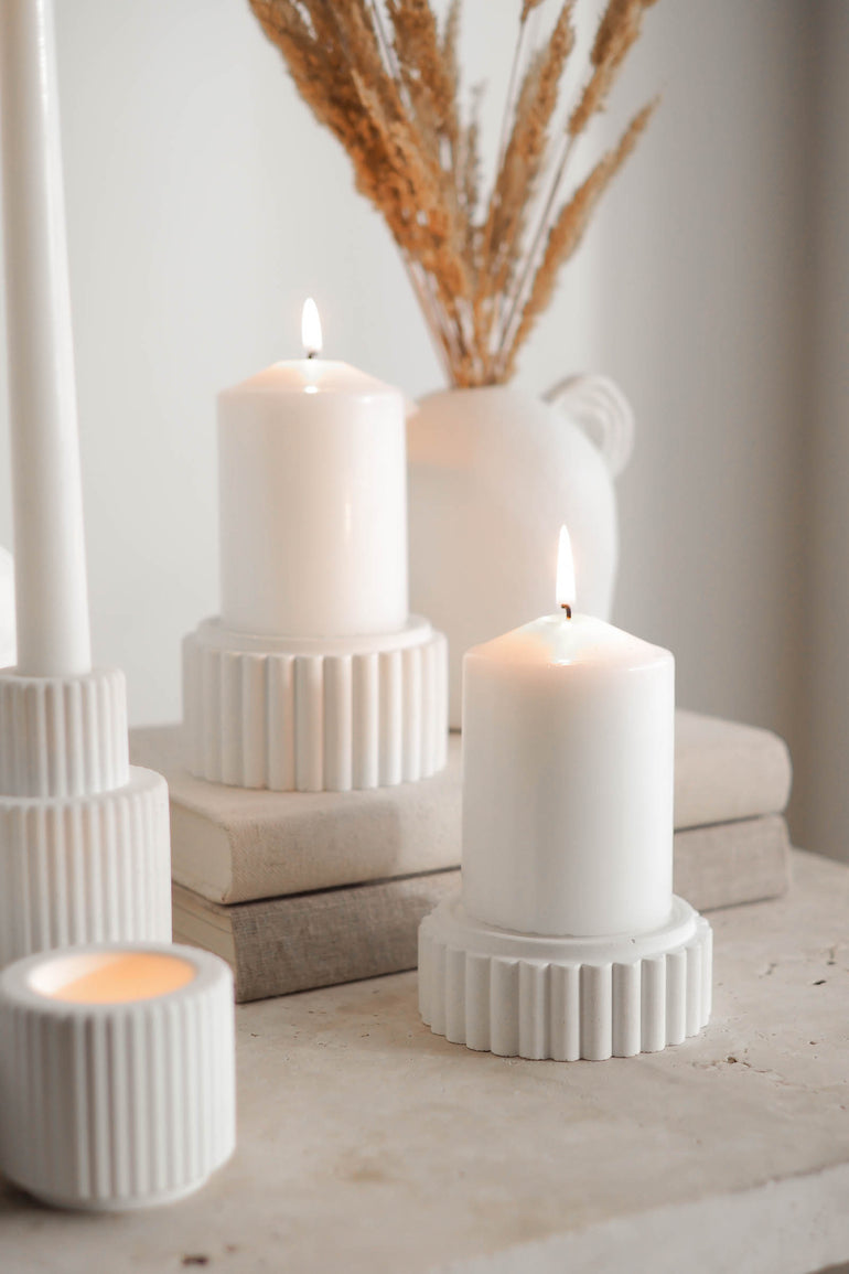 Preston candle holders with lit pillar candles