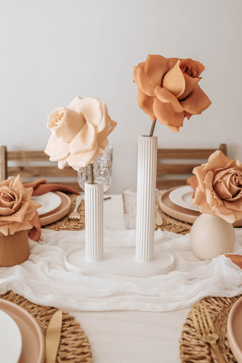 Sterling concrete vase displayed two single rose stems as a centrepiece for a wedding table display