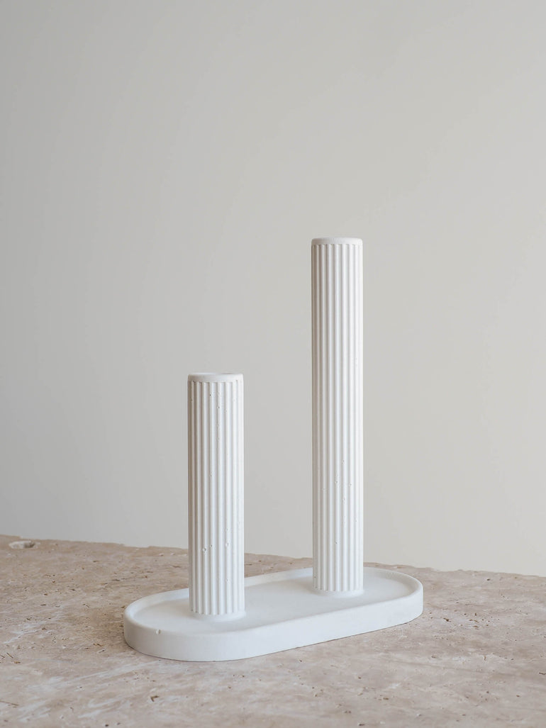 Sterling single stem vase made out of off white concrete with a ribbed texture